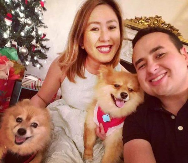 couple-2dogs couple with their two little dogs next to christmas tree