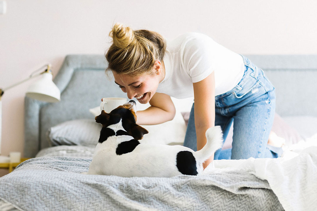 emotional-support-animal-faq Woman playing with her Emotional Support Animal