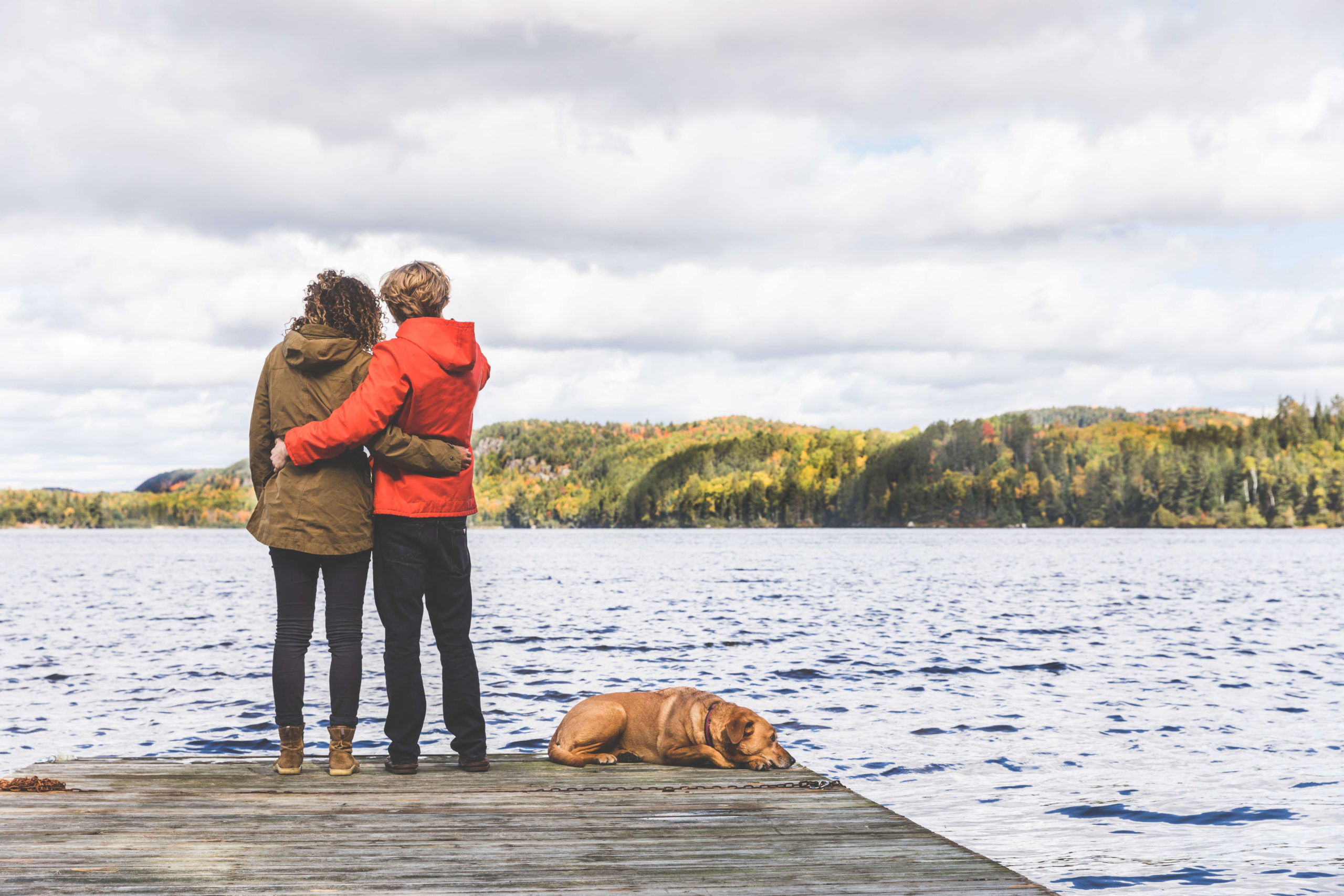 Couple at lake with dog emotional support dog Canada